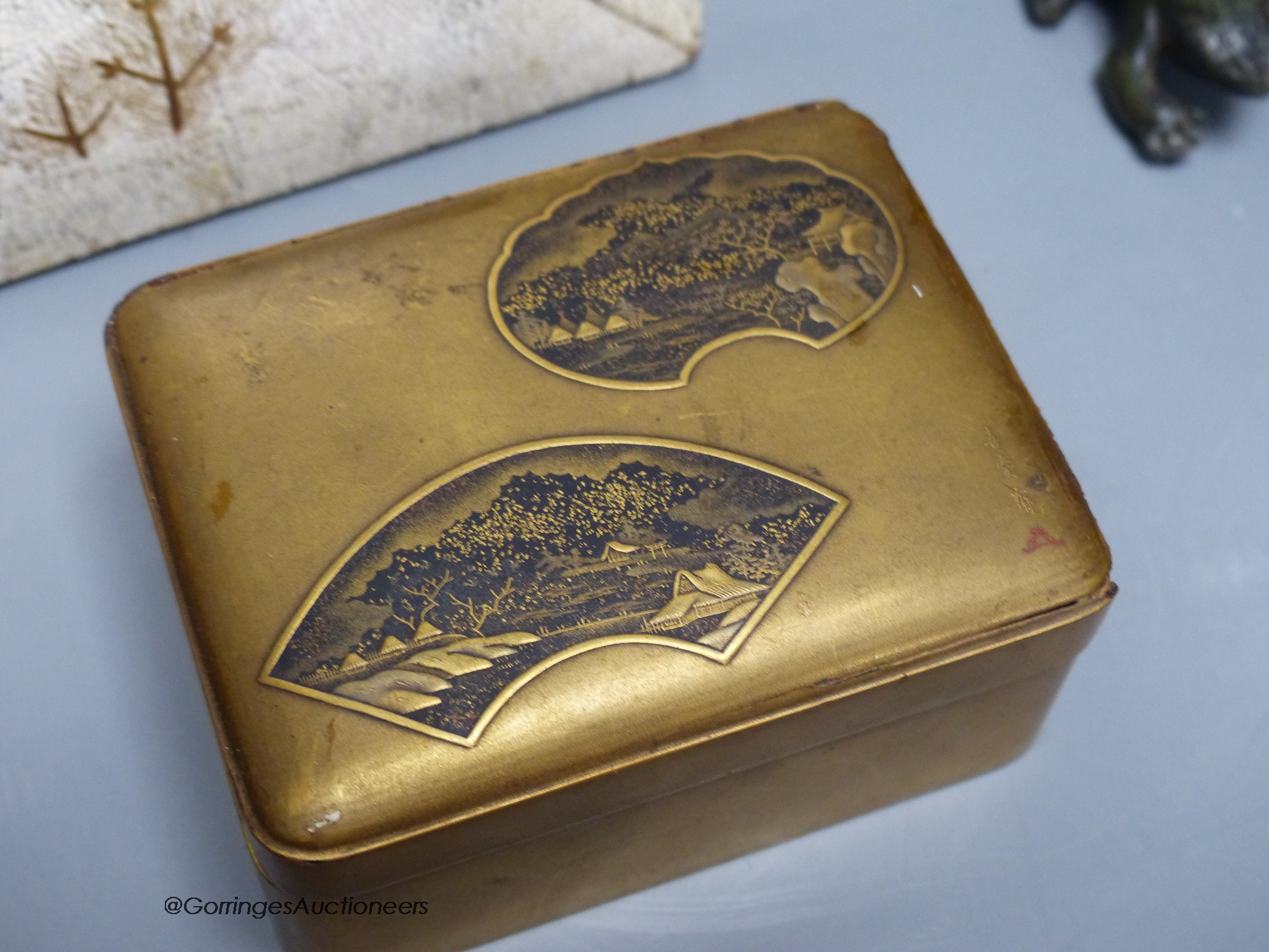 A Japanese lacquer jar and cover, a box and cover, a photo frame,22 x 18cm and an antimony figure of Gama Senin